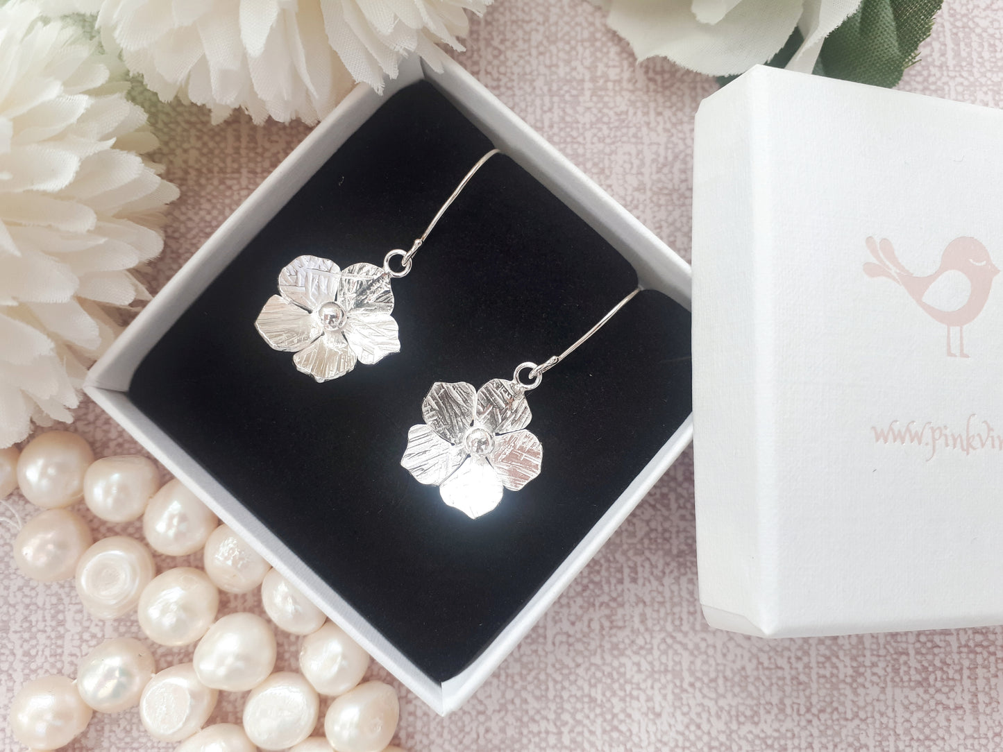 Flower drop earrings in sterling silver.