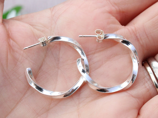 Handmade sterling silver twisted hoop earrings.