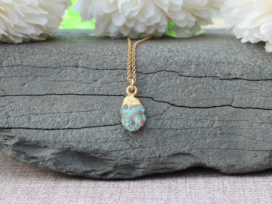 Raw turquoise necklace in gold.