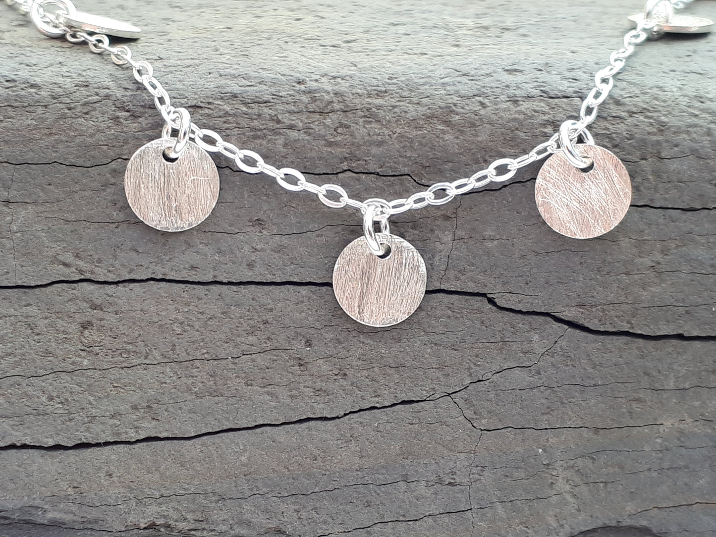 Silver disc necklace.
