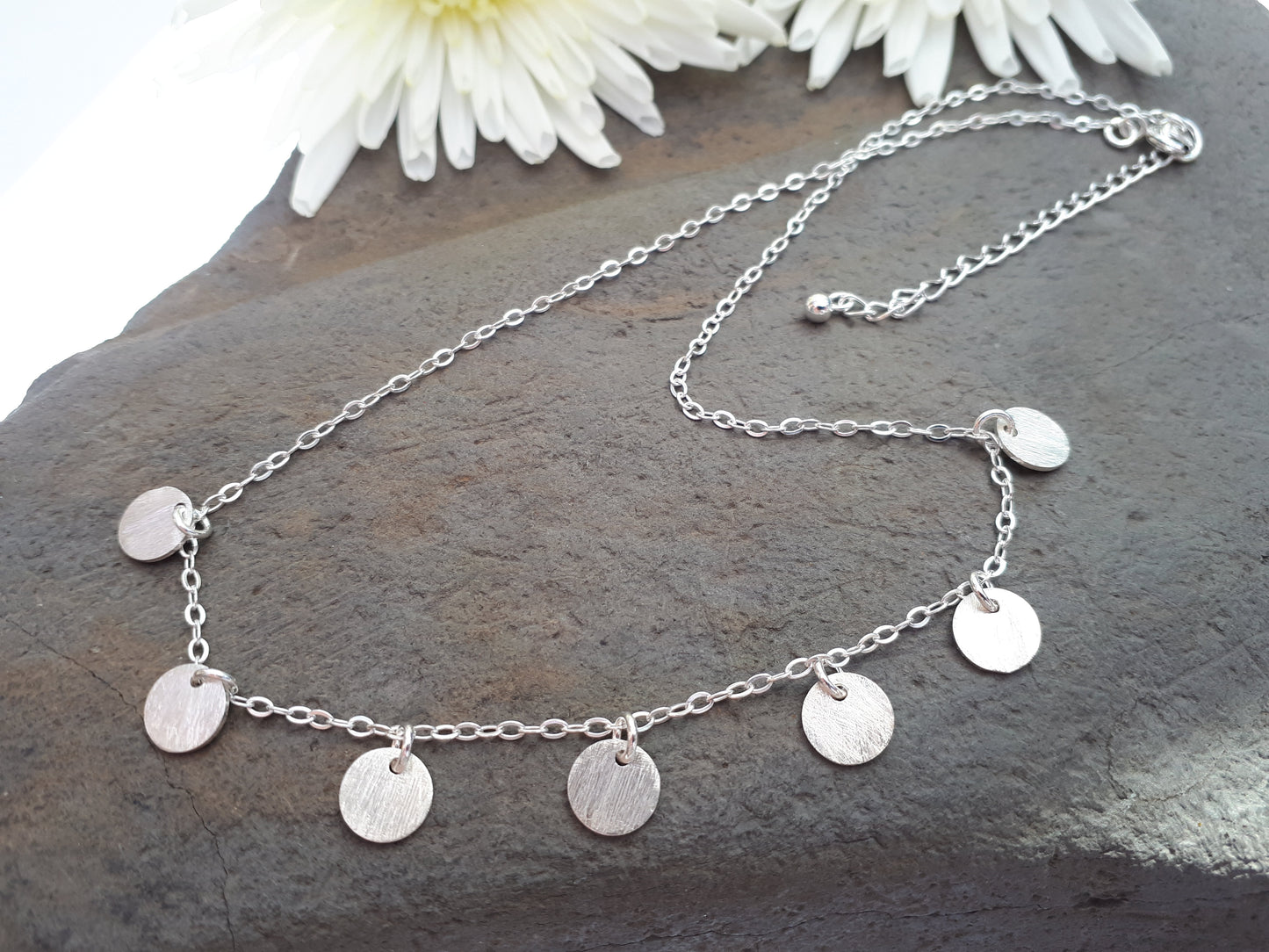 Silver disc necklace.