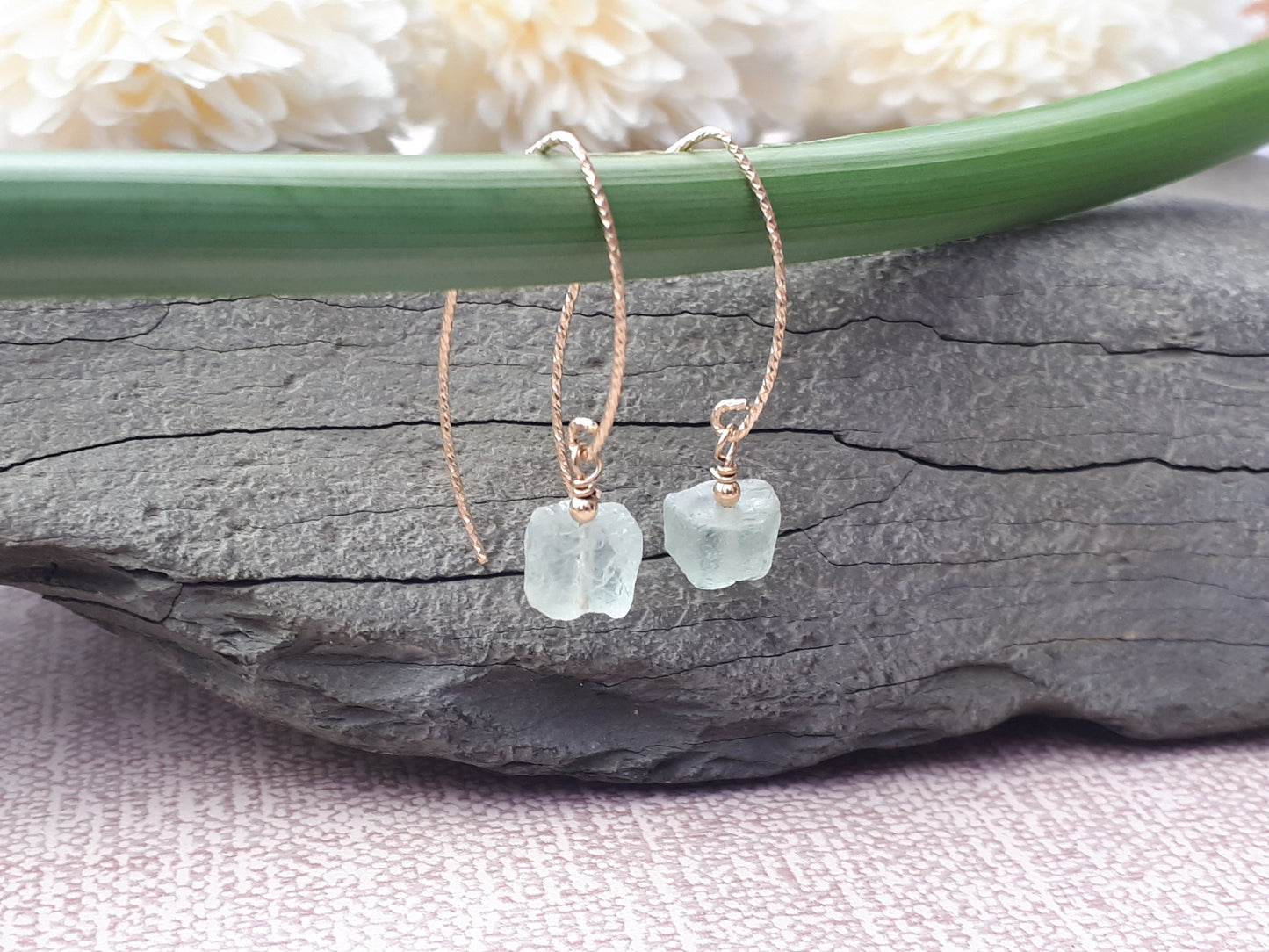 Raw aquamarine earrings in gold.