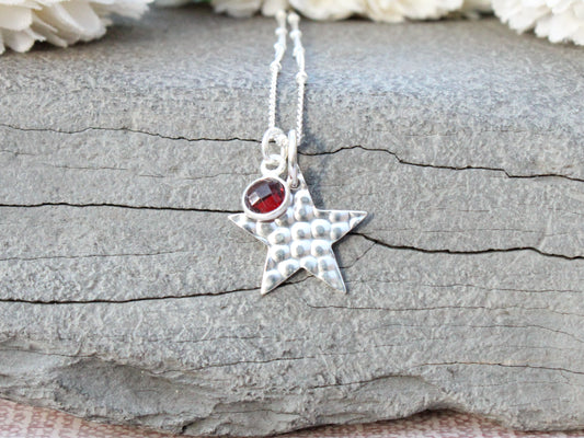 Hammered star necklace in sterling silver.