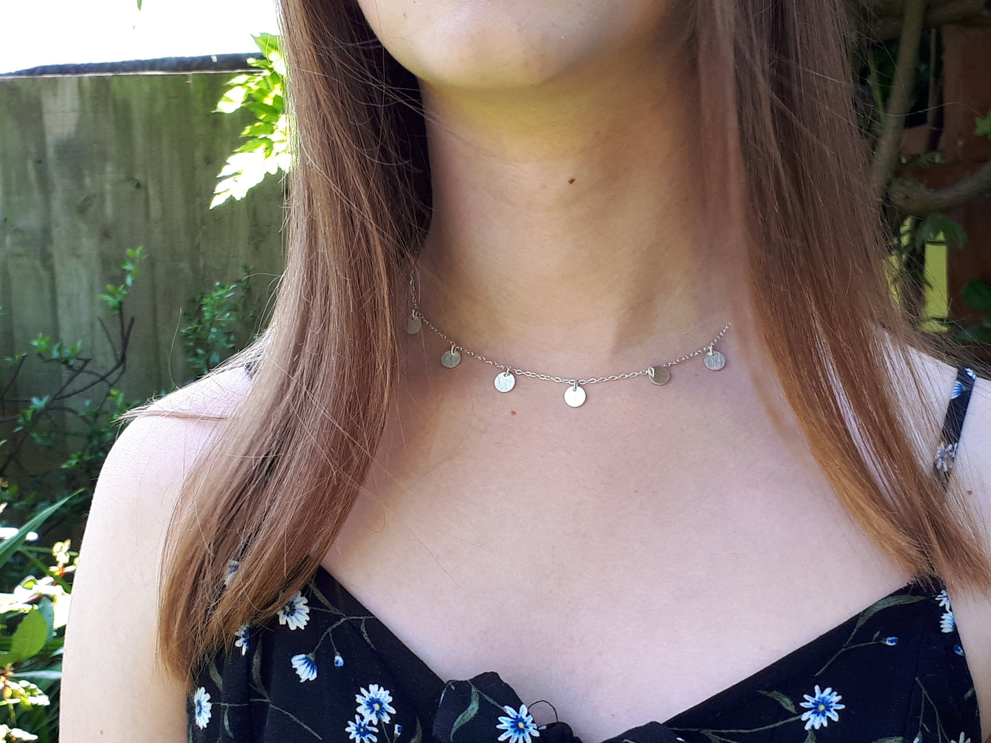 Silver disc necklace.
