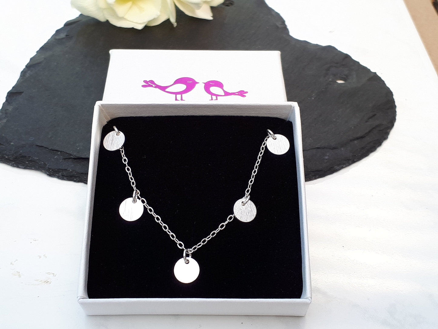 Silver disc necklace.