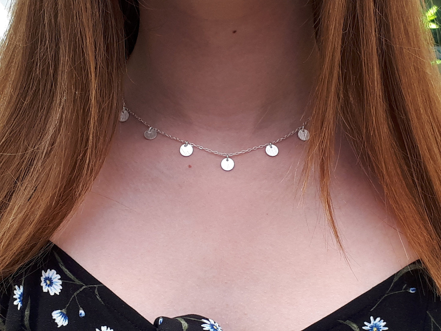 Silver disc necklace.