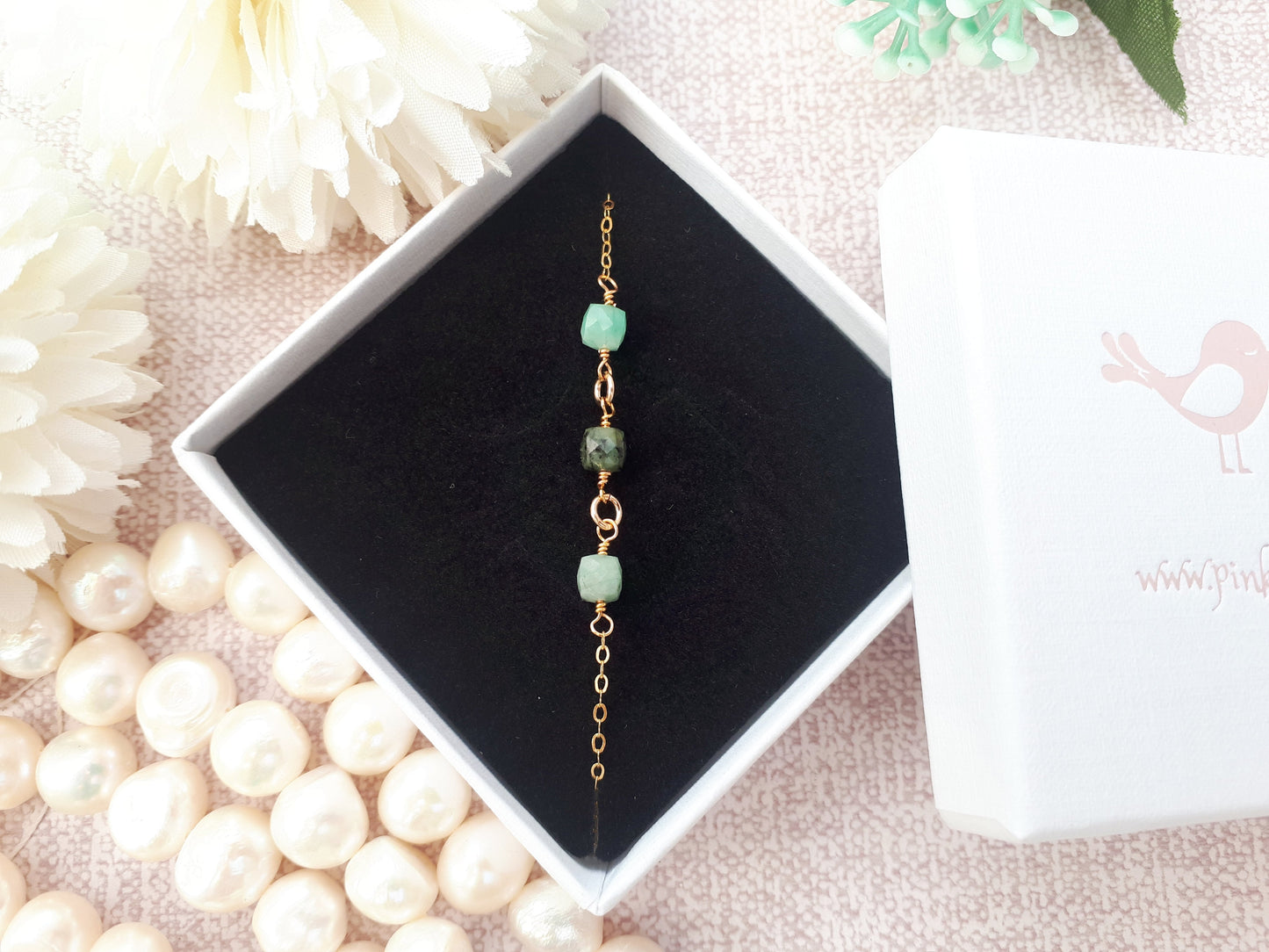 Emerald gemstone necklace in silver or gold.