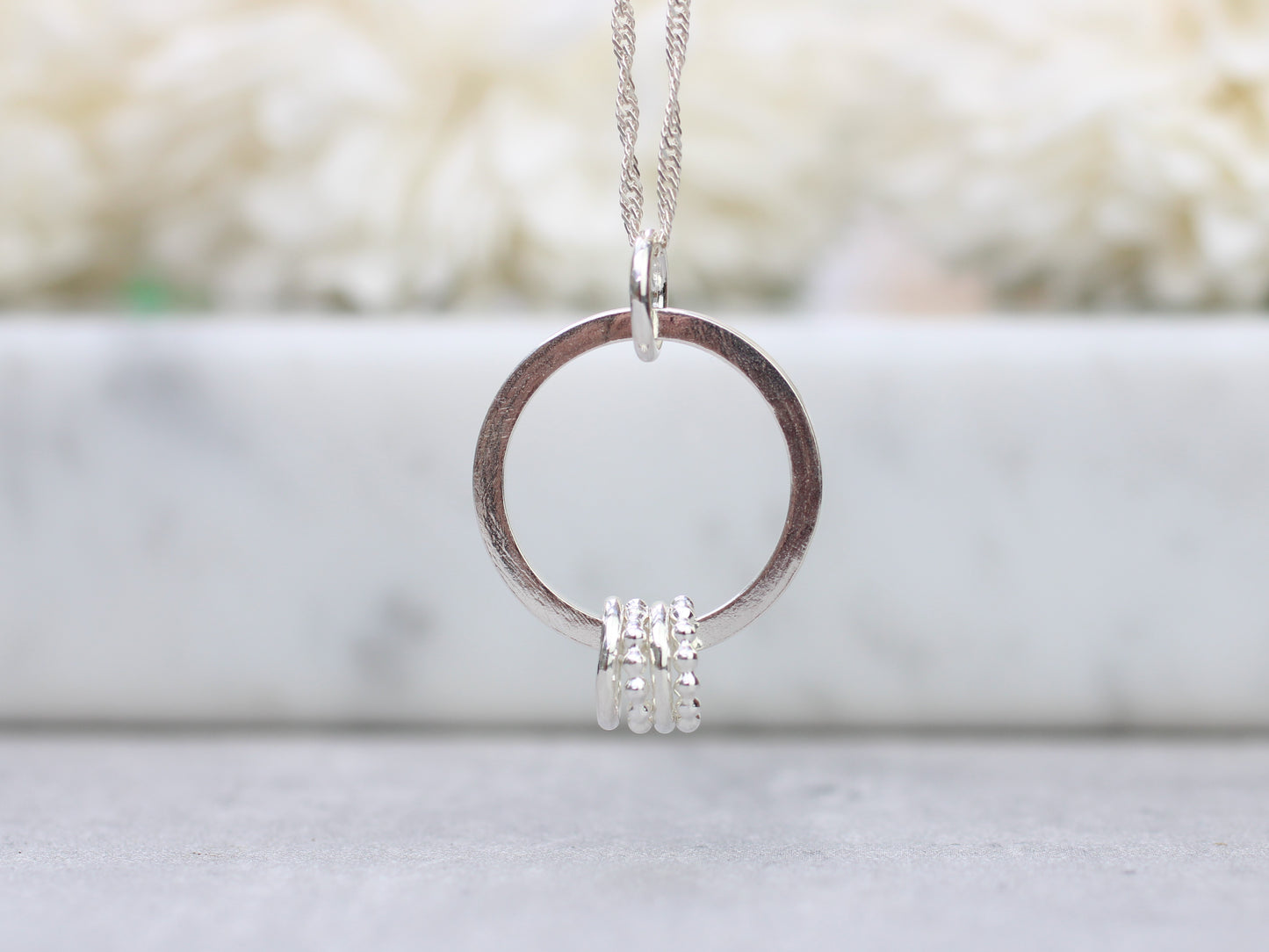 40th birthday necklace with 4 rings.