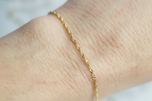 gold chain on a wrist