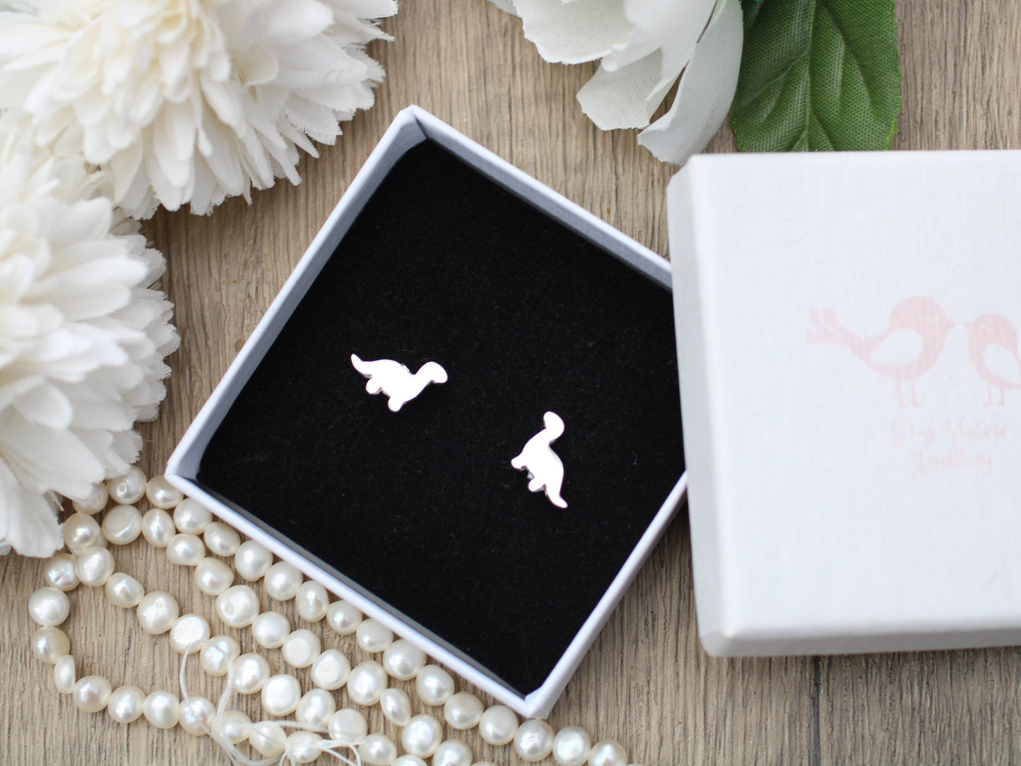 Diplodocus dinosaur stud earrings in silver.