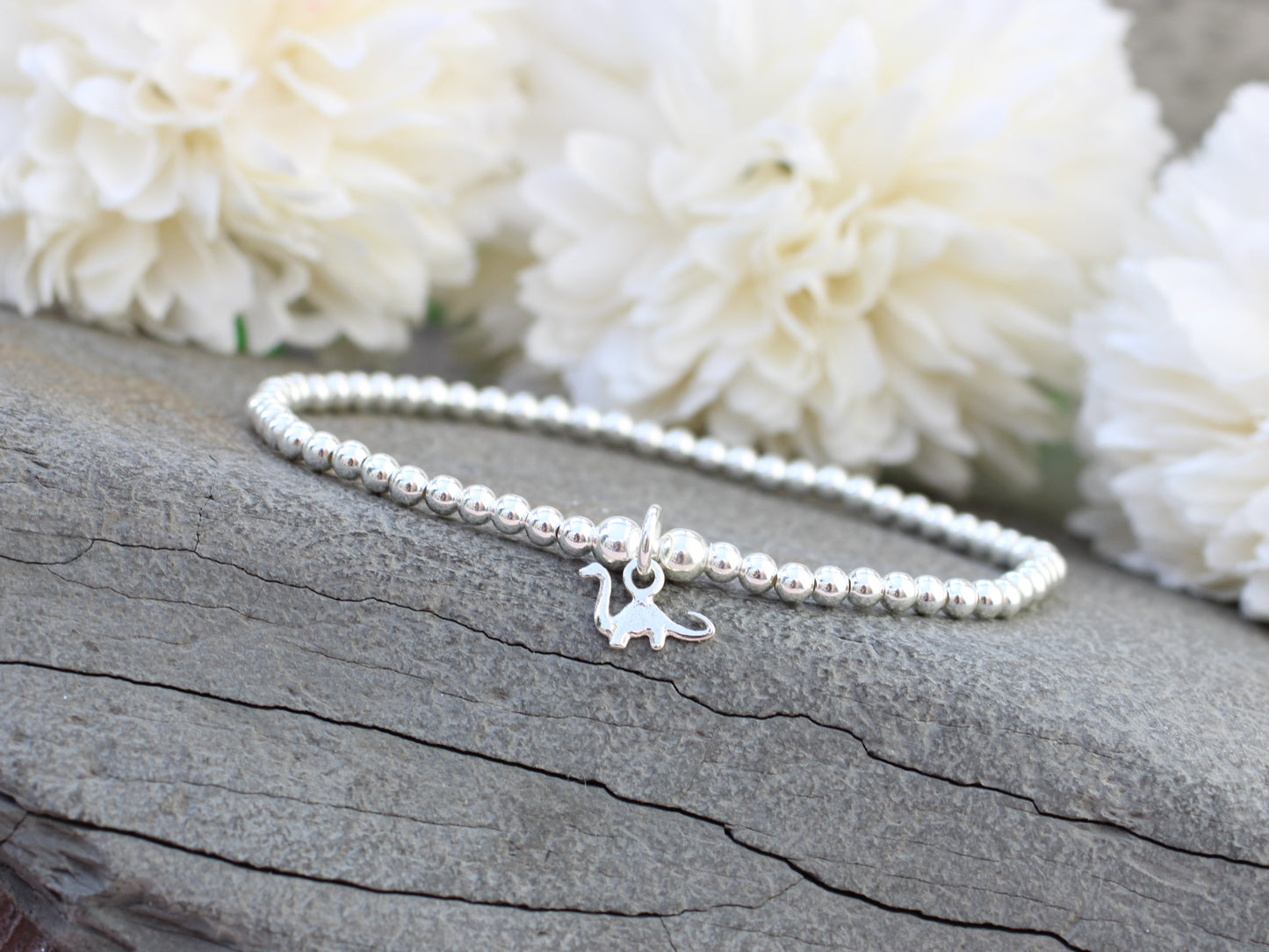 Silver dinosaur bracelet.