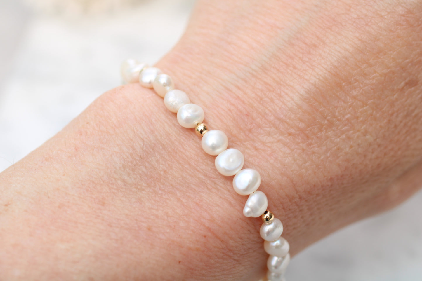 Pearl bracelet with gold clasp.