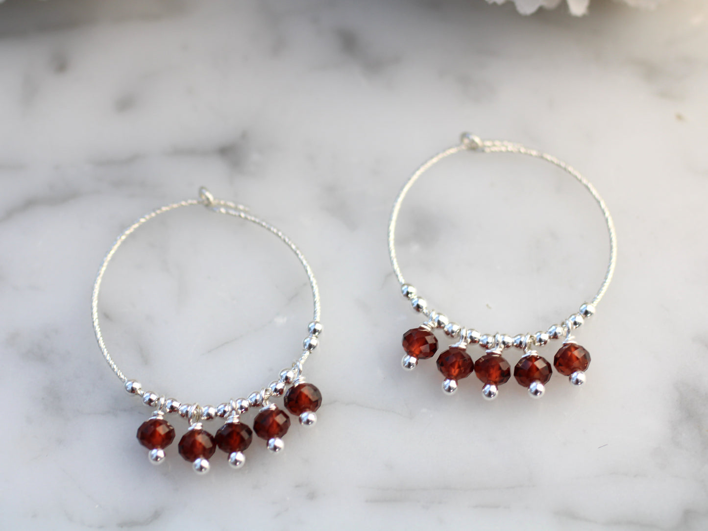 Sparkly garnet hoop earrings.