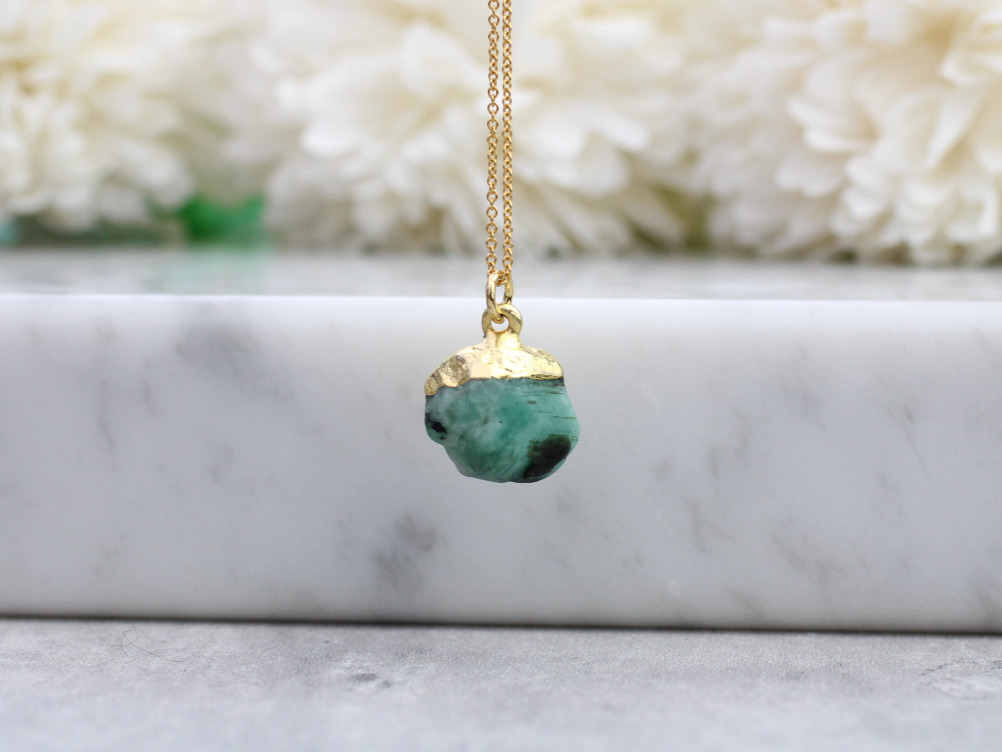 Raw emerald necklace in gold. May birthstone necklace.