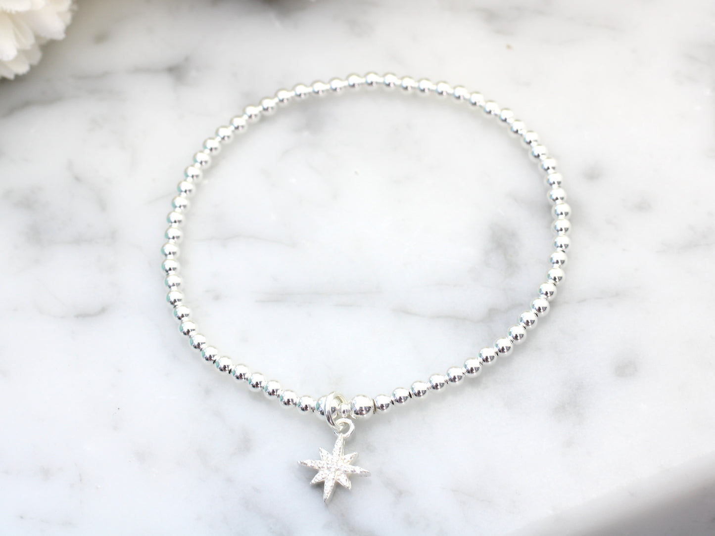 Beaded bracelet with north star charm.