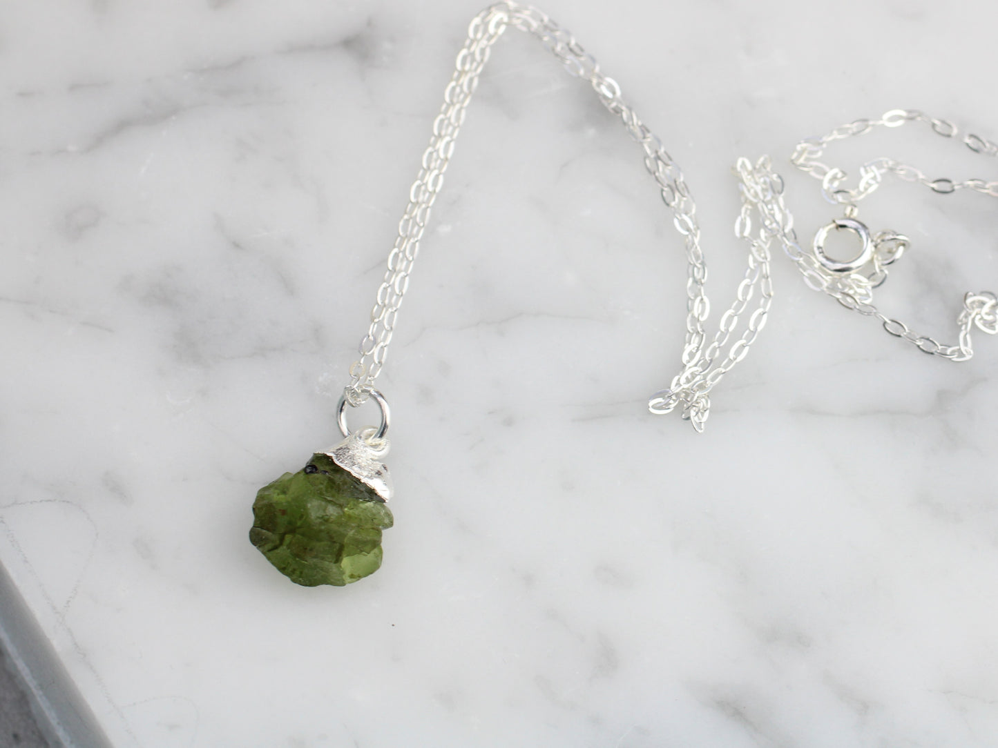 Raw peridot necklace in silver. August birthstone.