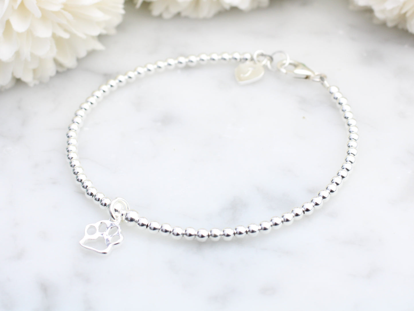 Sterling silver paw print bracelet. Pet remembrance gift.