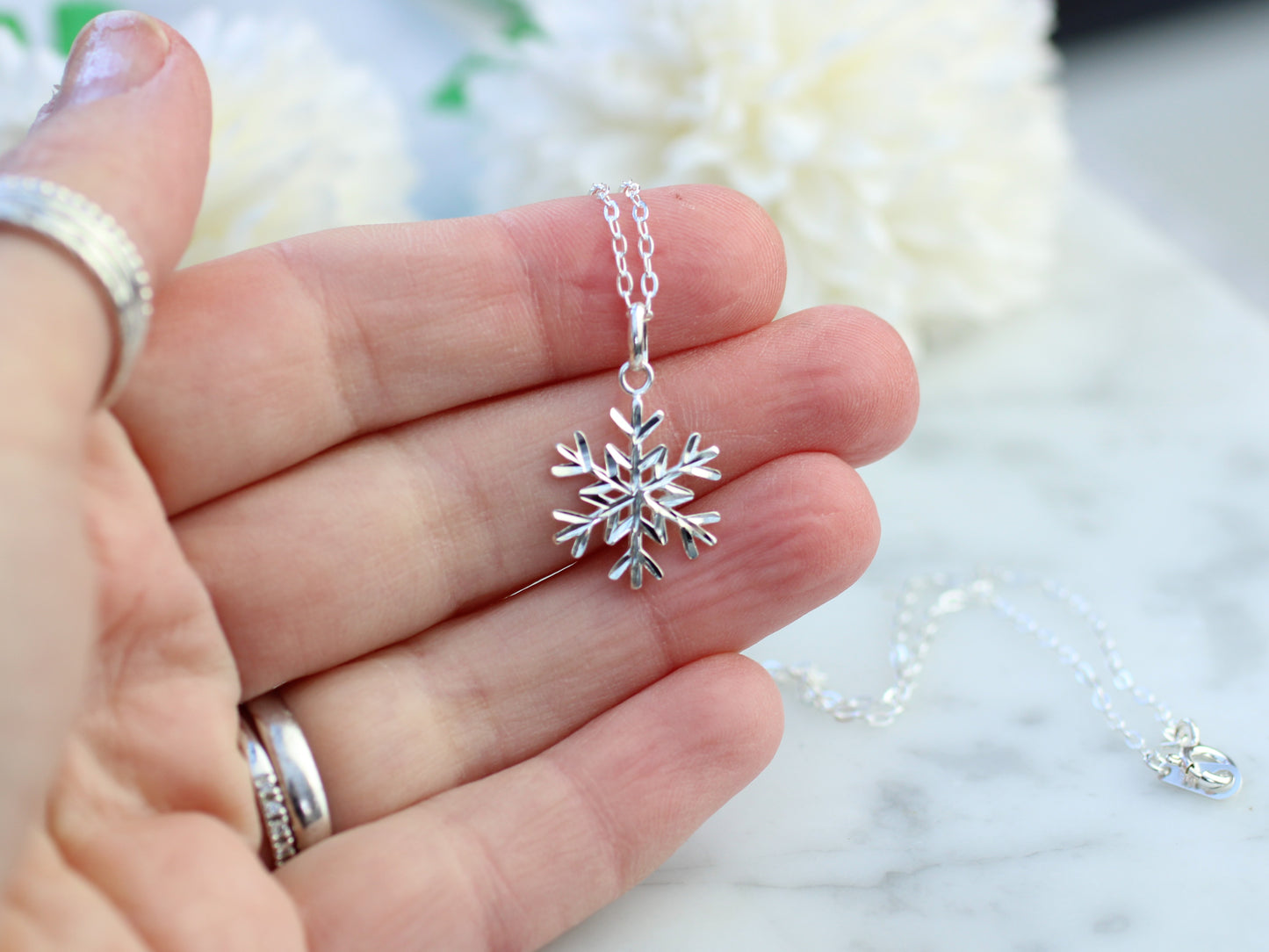 Diamond cut snowflake pendant necklace.