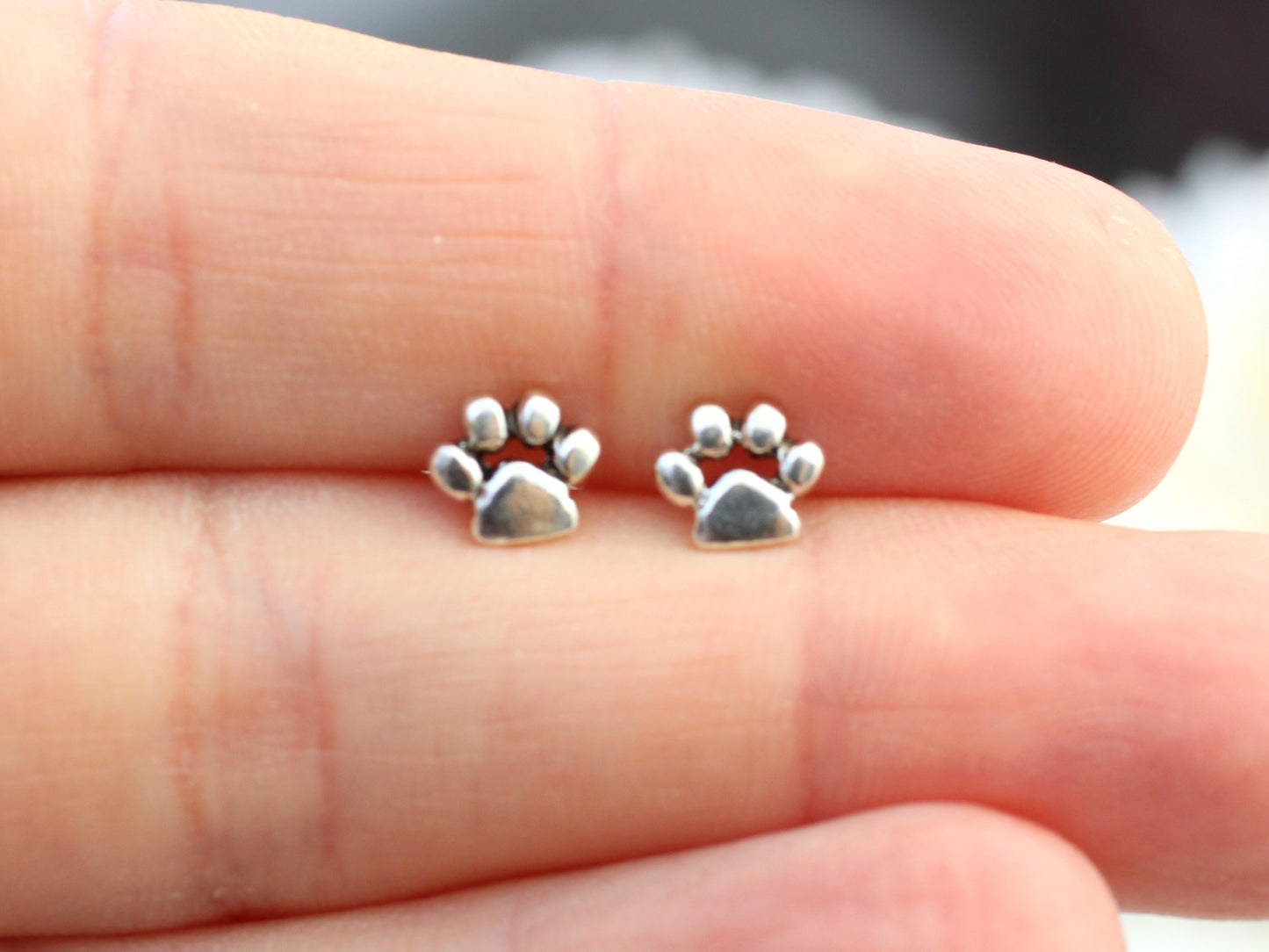 Sterling silver paw print earrings.