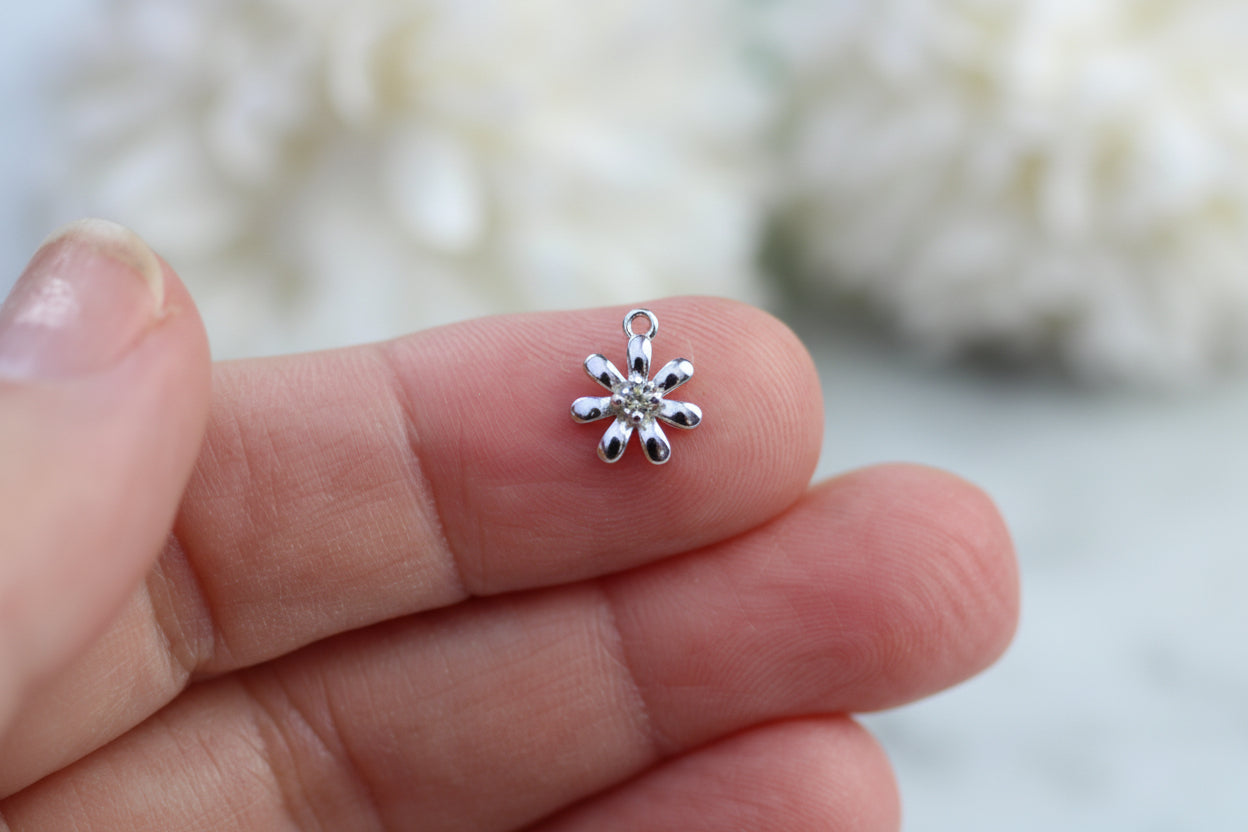 Flower charm with yellow crystal.