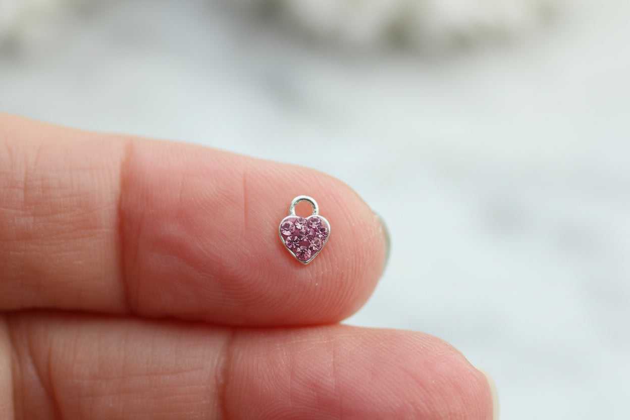 Pink cubic zirconia heart charm.