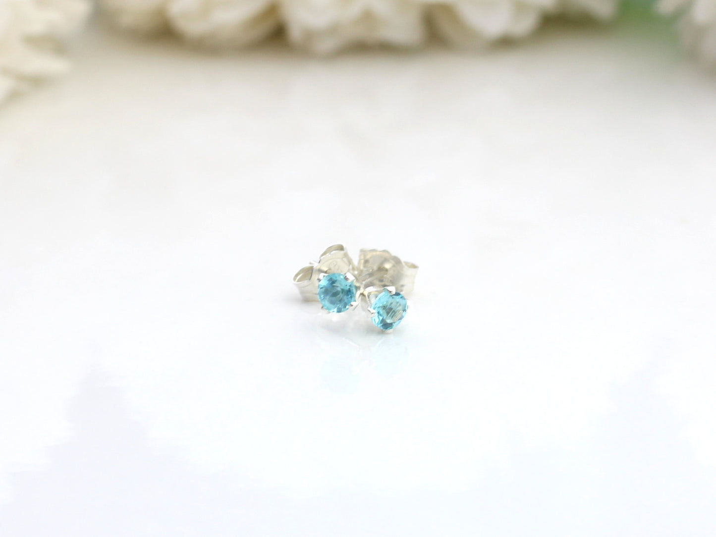 Apatite stud earrings in sterling silver or gold .