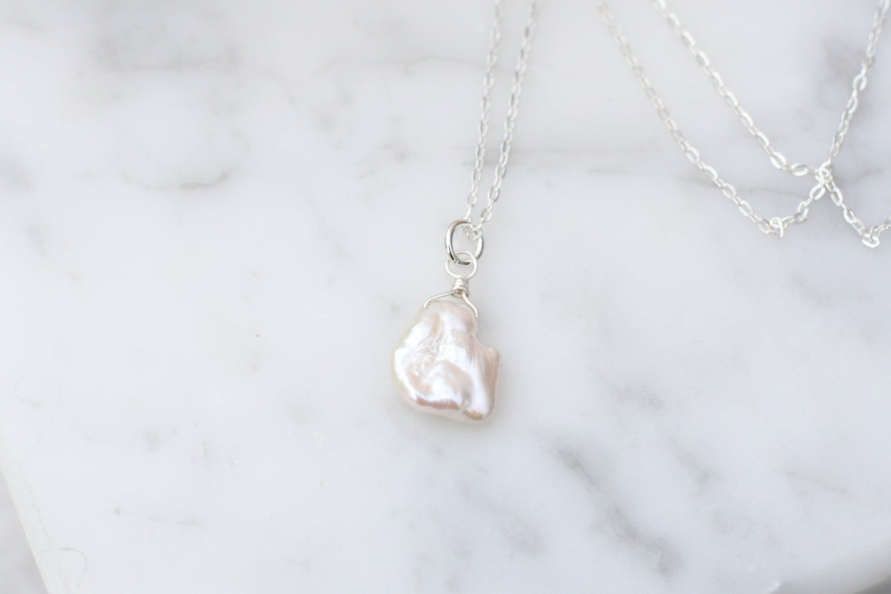 Pearl necklace on a marble surface