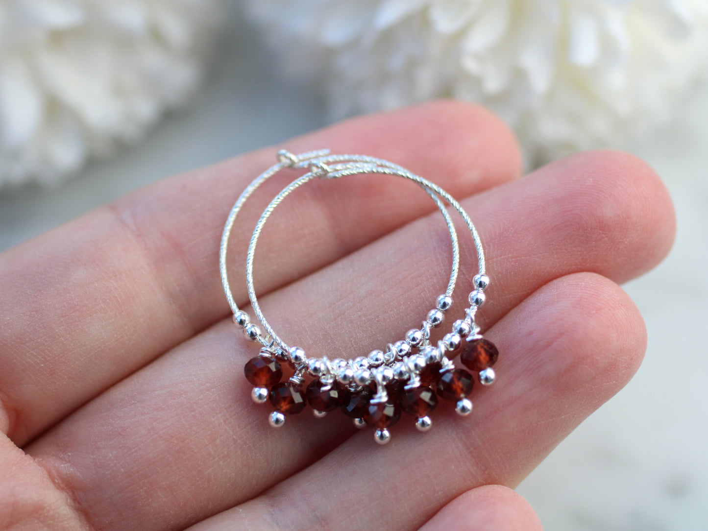 Sparkly garnet hoop earrings.