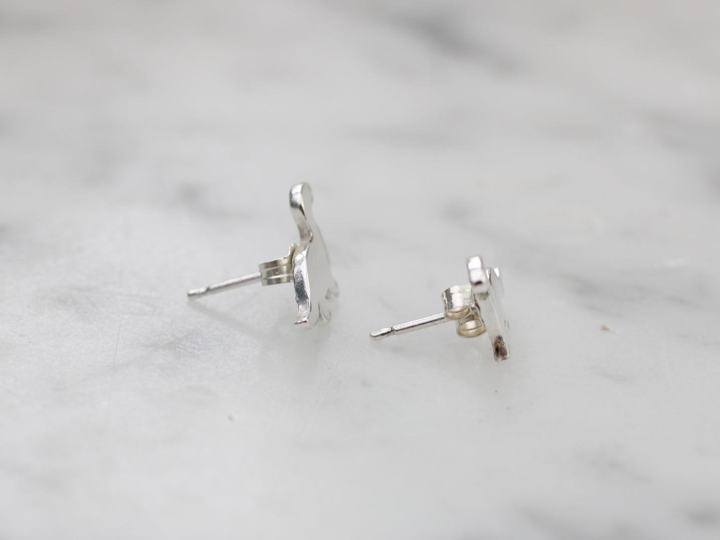 Diplodocus dinosaur stud earrings in silver.