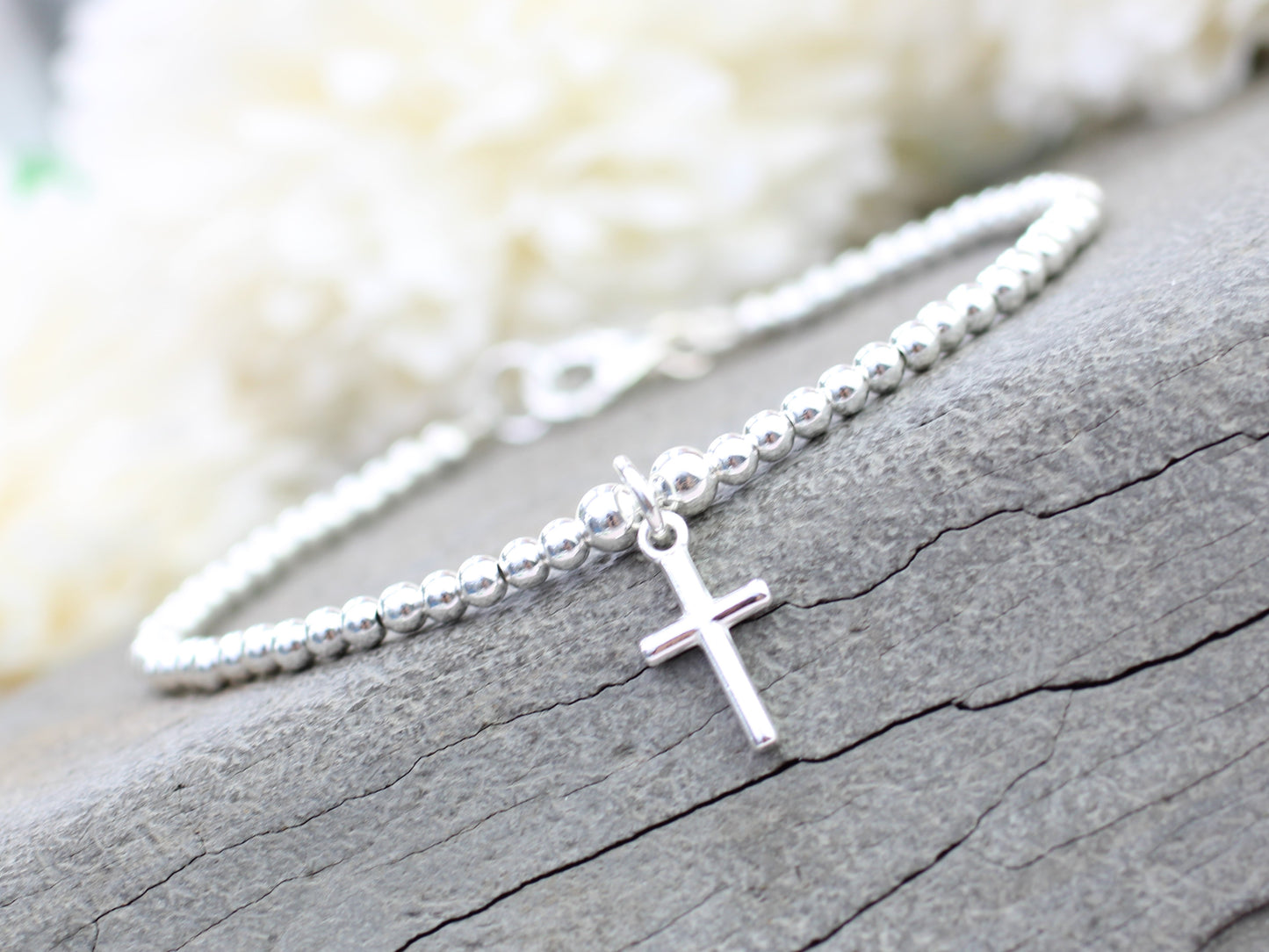 Silver beaded cross bracelet.