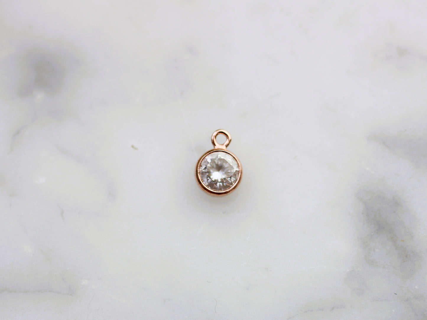 Rose gold crystal charm.