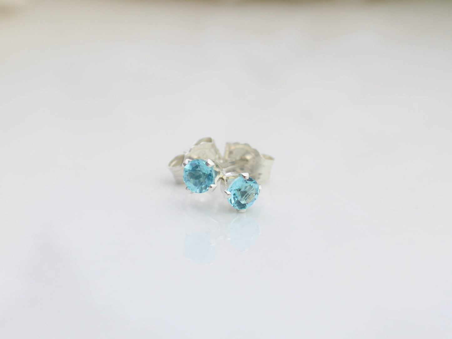 Apatite stud earrings in sterling silver or gold .