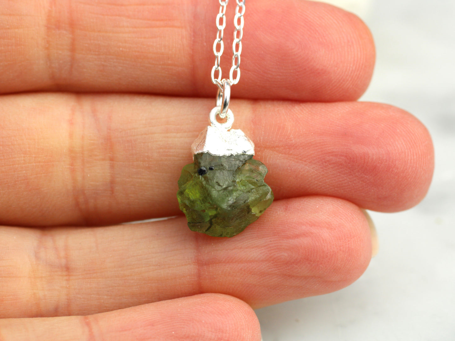 Raw peridot necklace in silver. August birthstone.