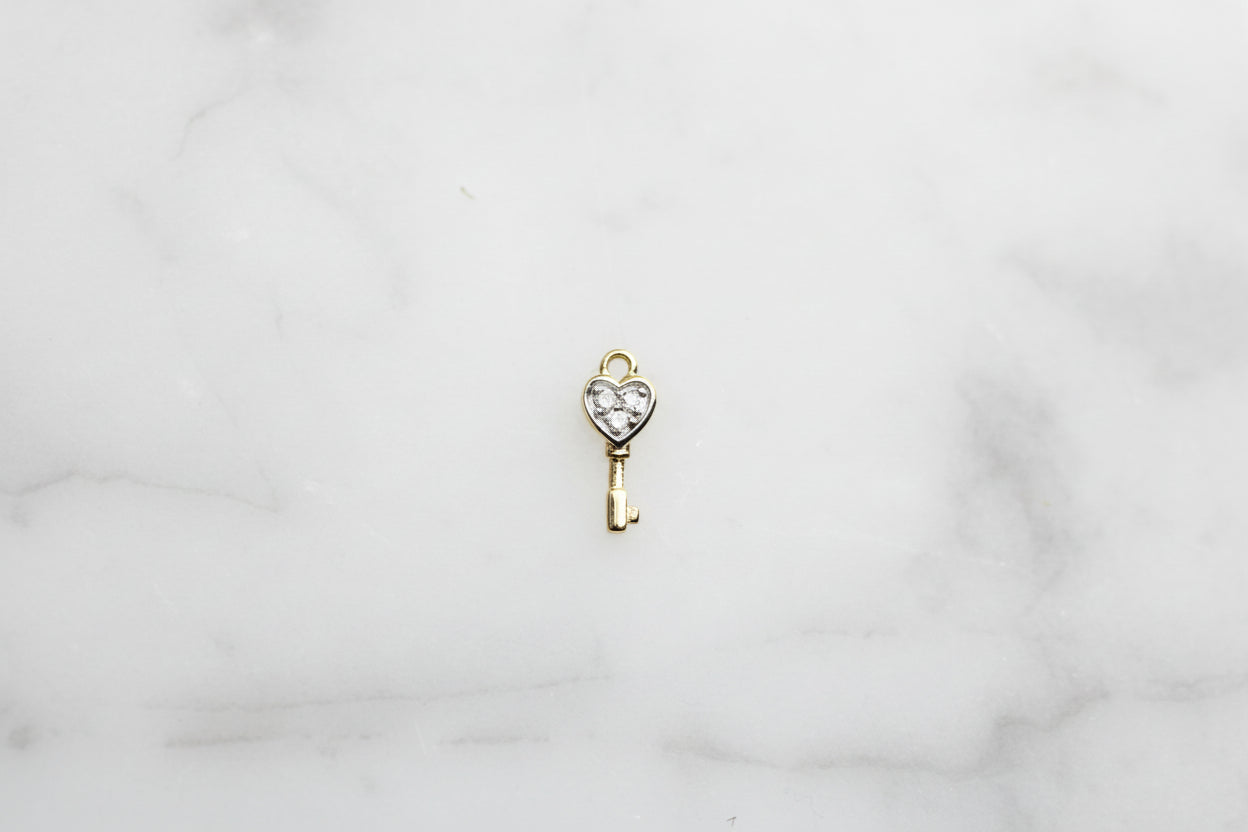 14ct gold diamond key charm.