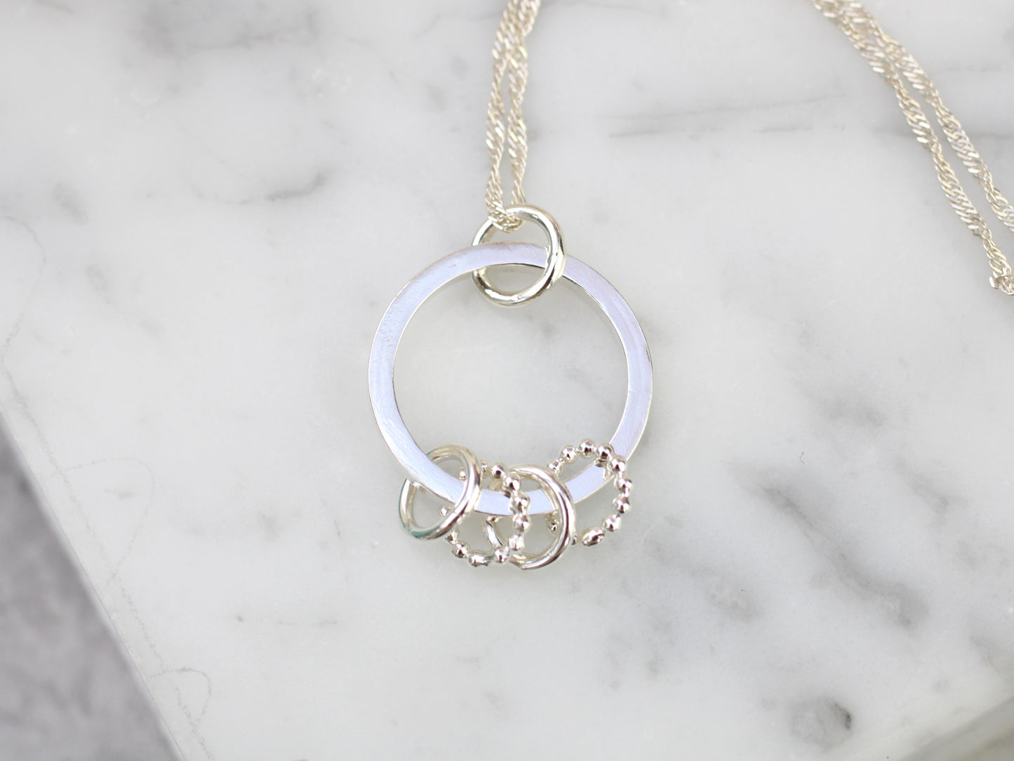 40th birthday necklace with 4 rings.