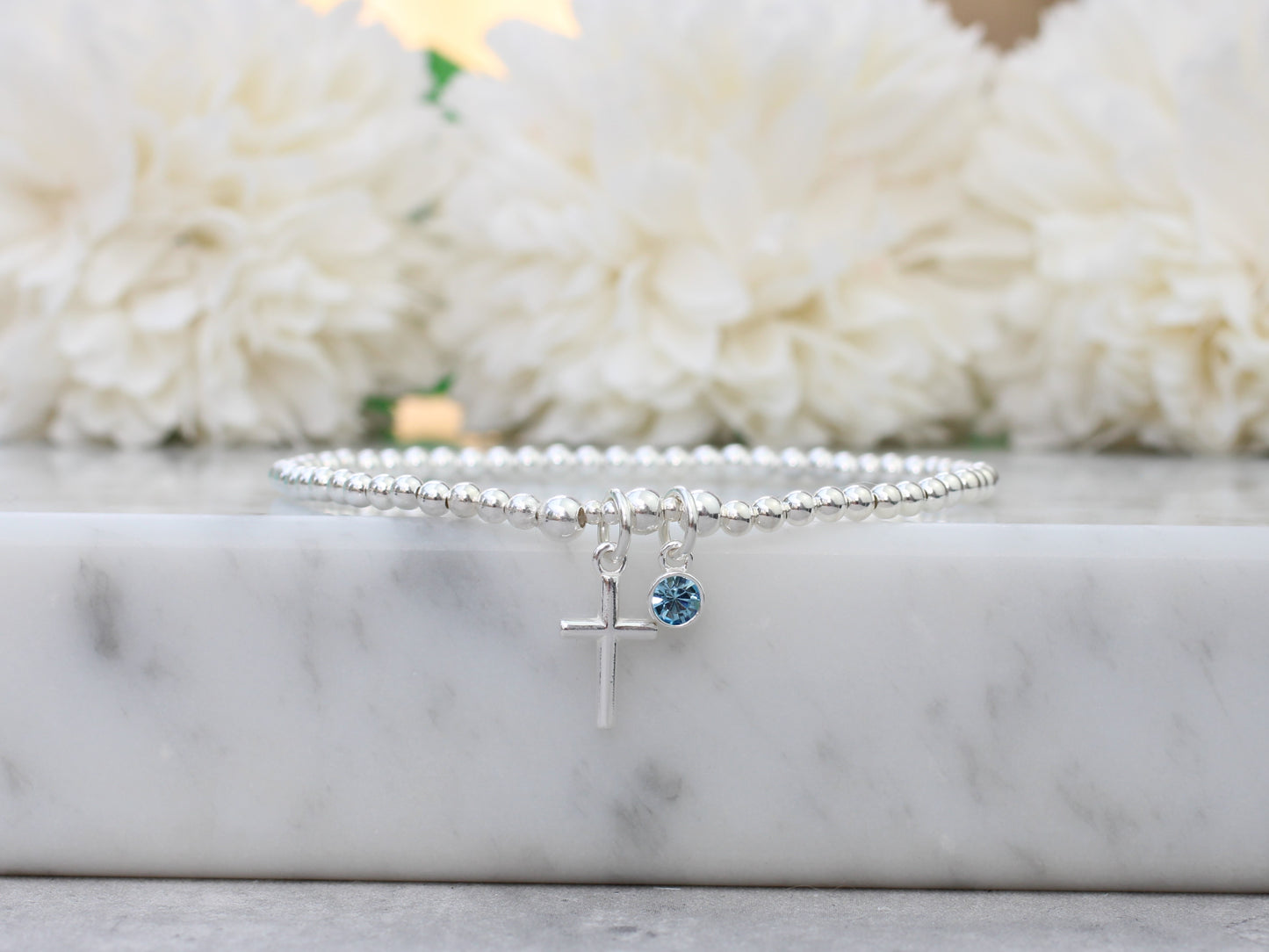 Cross bracelet with birthstone charm.