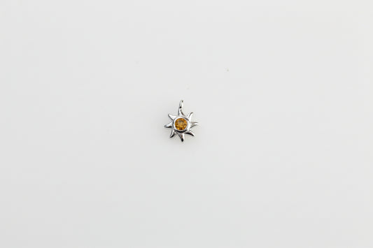 Sun charm with yellow crystal.