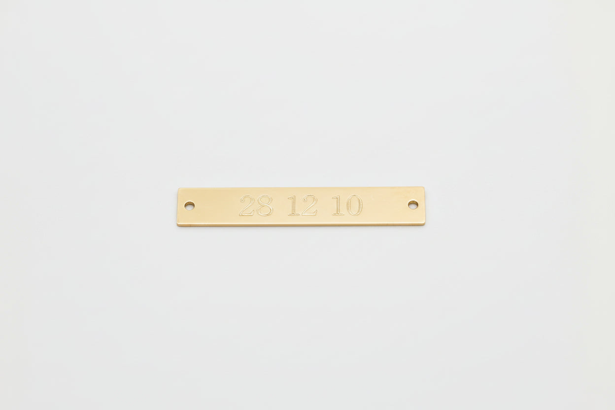 Engraved gold filled rectangular tag.
