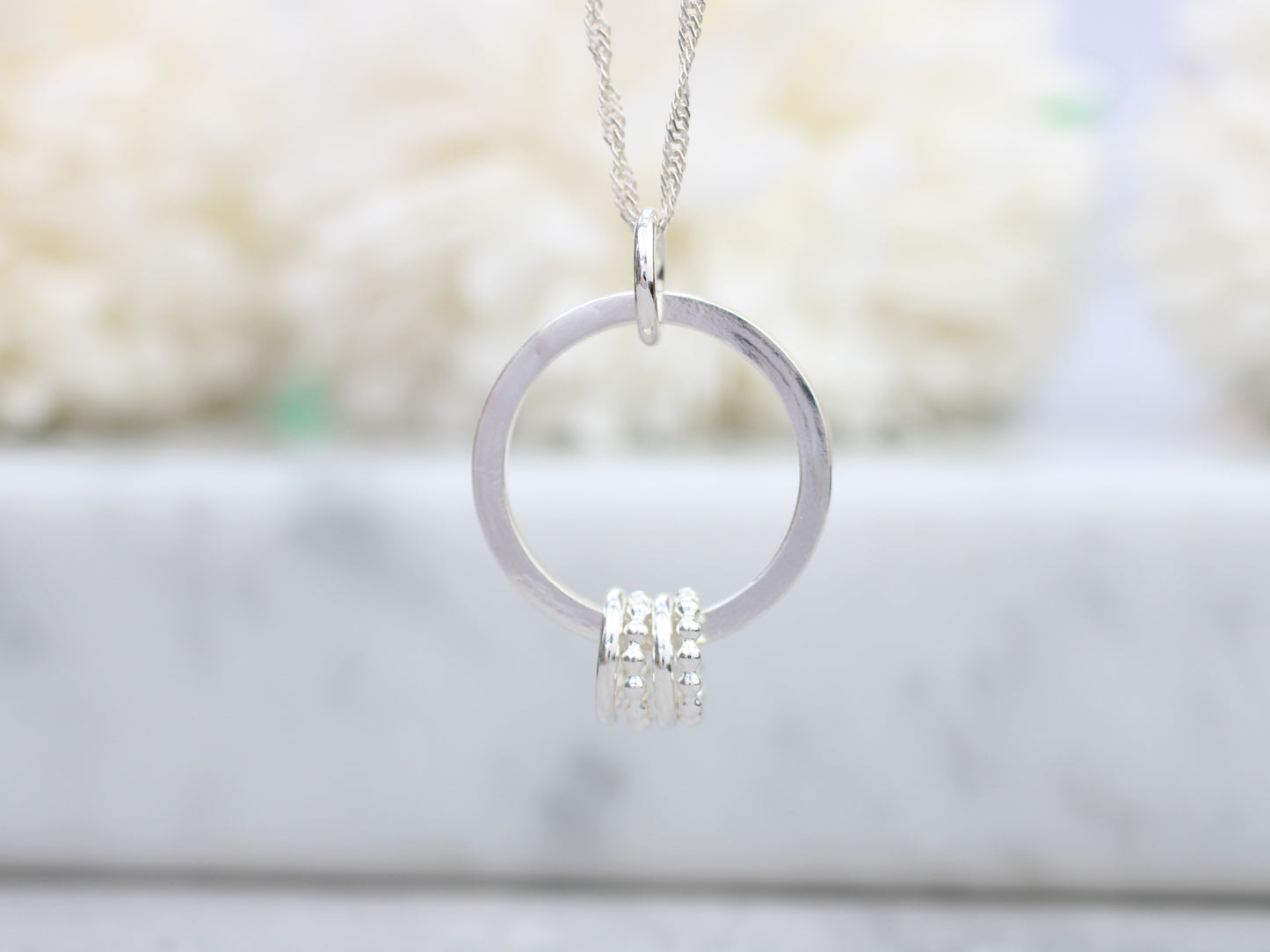 40th birthday necklace with 4 rings.