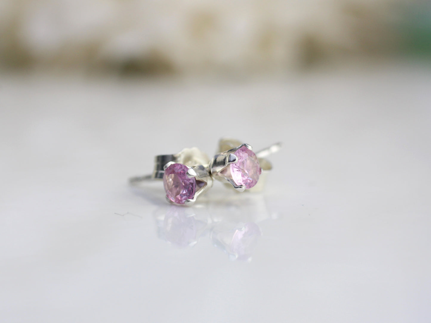 Pink sapphire stud earrings in silver or gold.