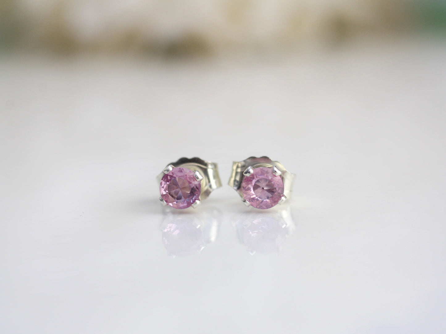 Pink sapphire stud earrings in silver or gold.