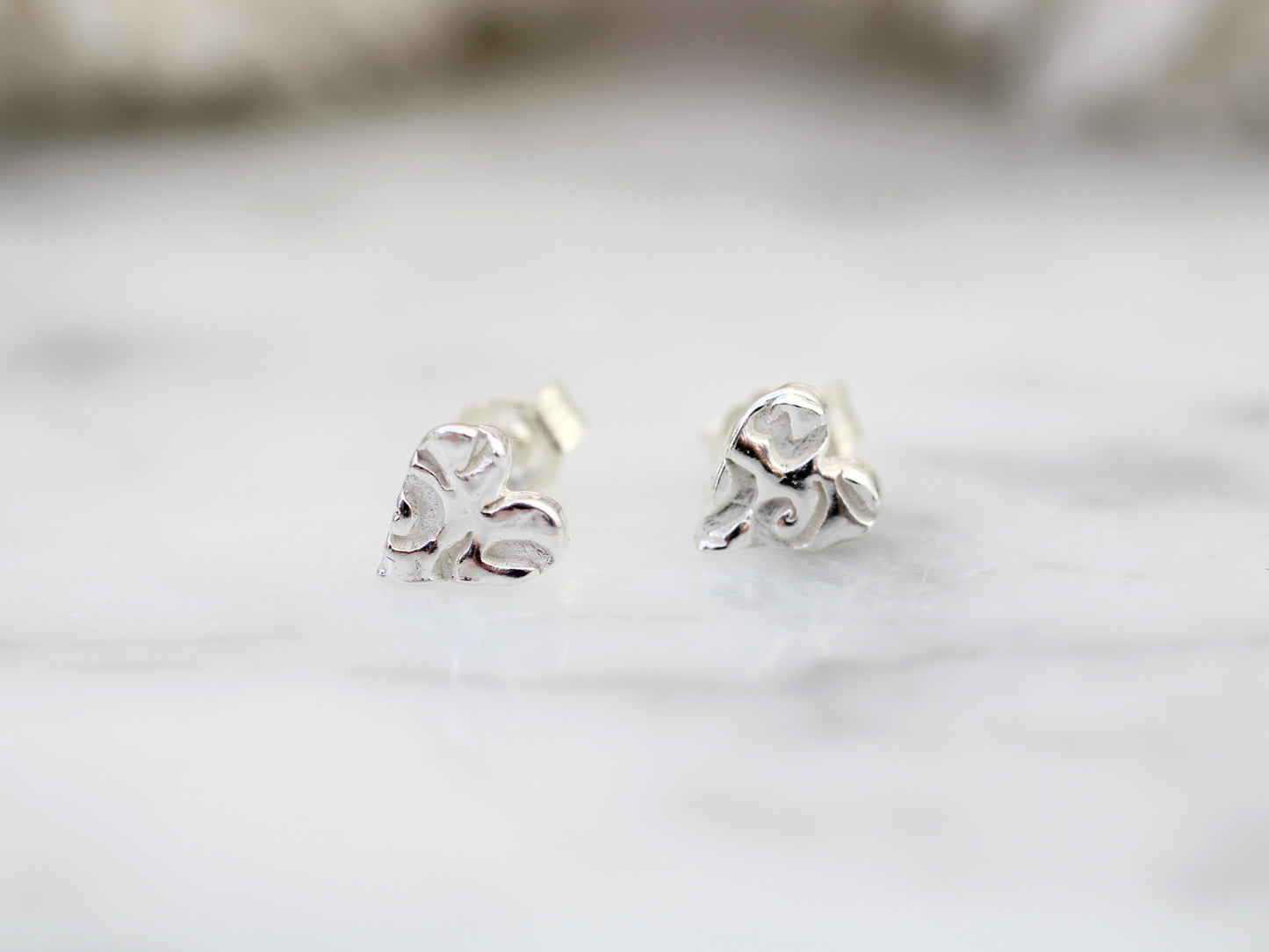 Pure silver heart stud earrings.