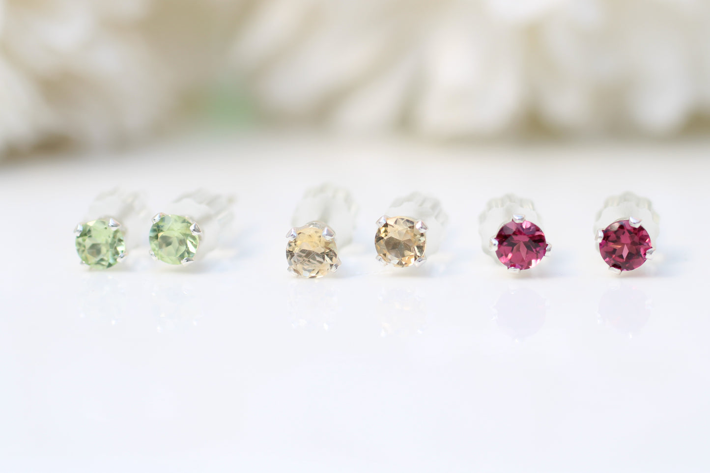 Set of gemstone earrings on a white background