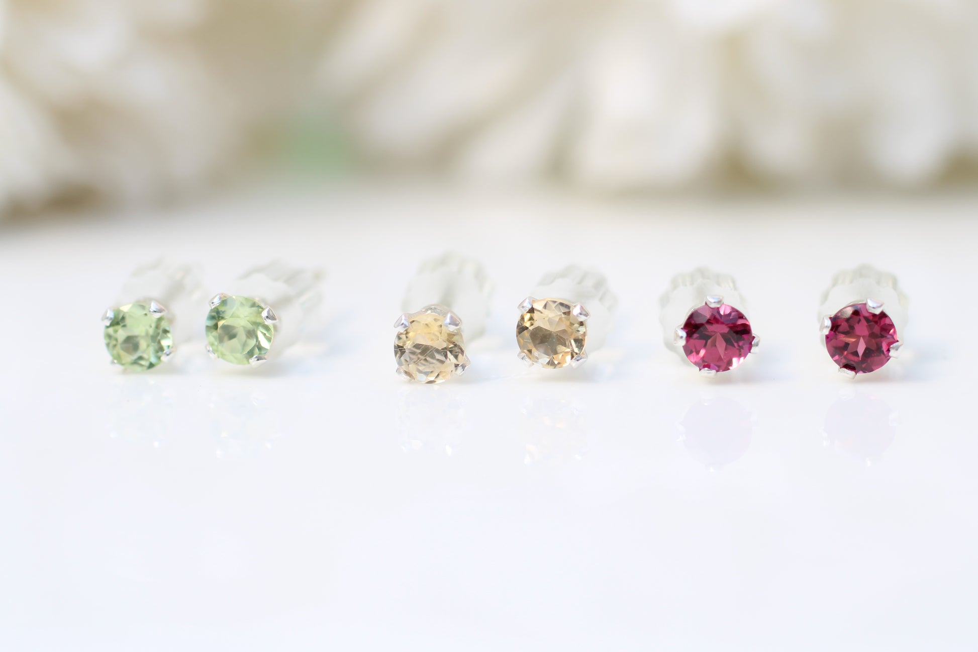 Set of gemstone earrings on a white background
