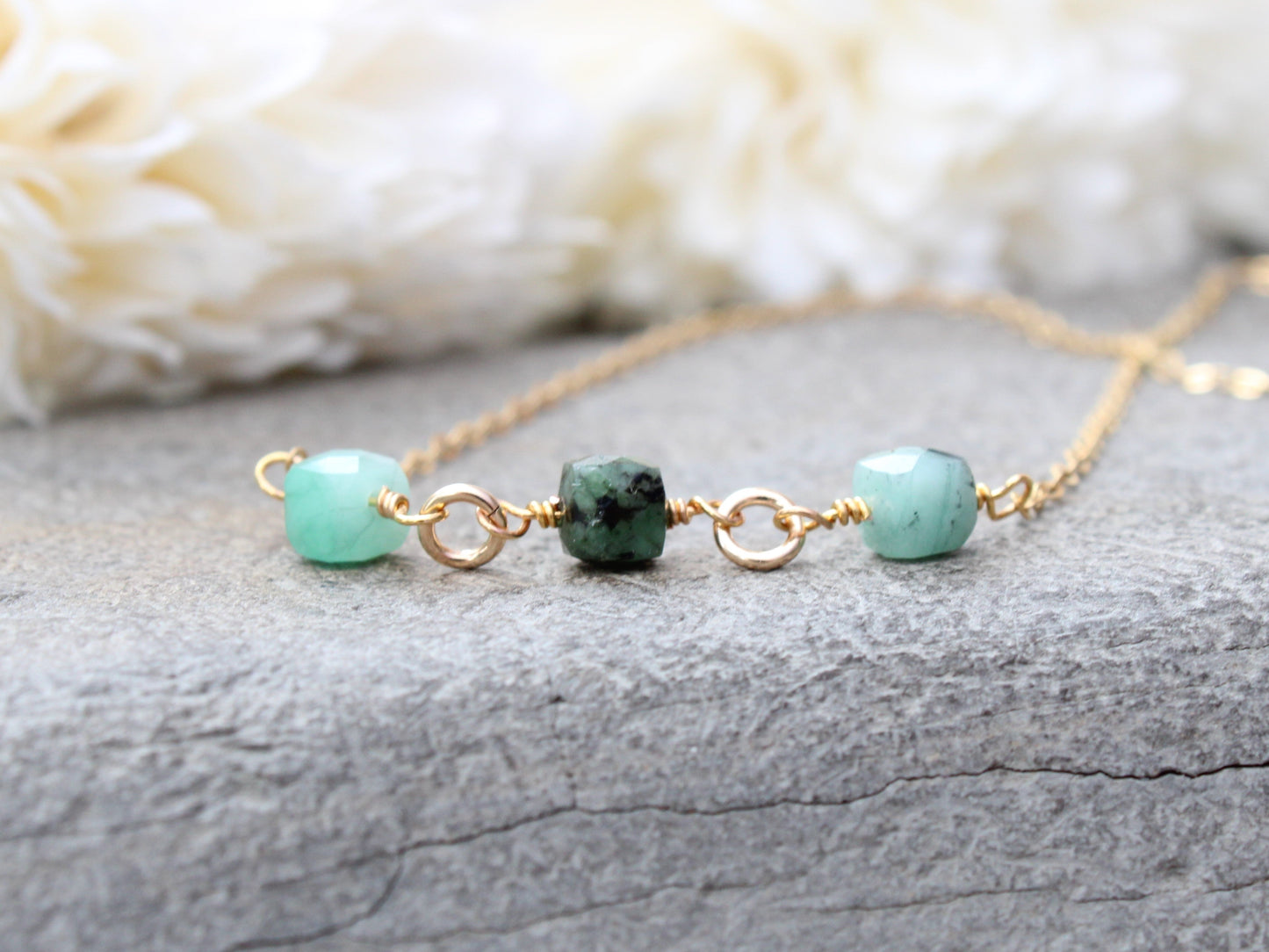 Emerald gemstone necklace in silver or gold.