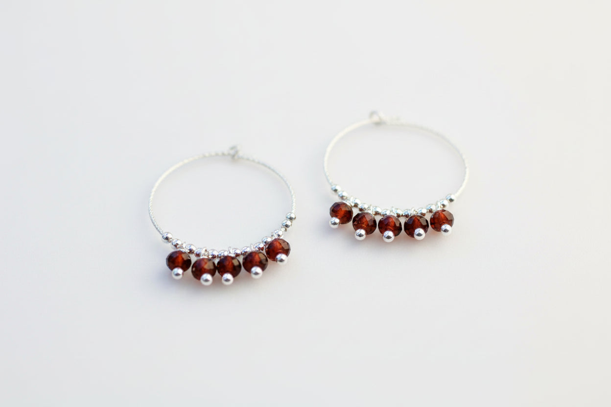 Sparkly garnet hoop earrings.