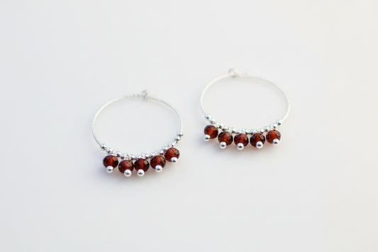 Sparkly garnet hoop earrings.