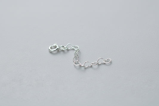 Silver chain on a pink textured background