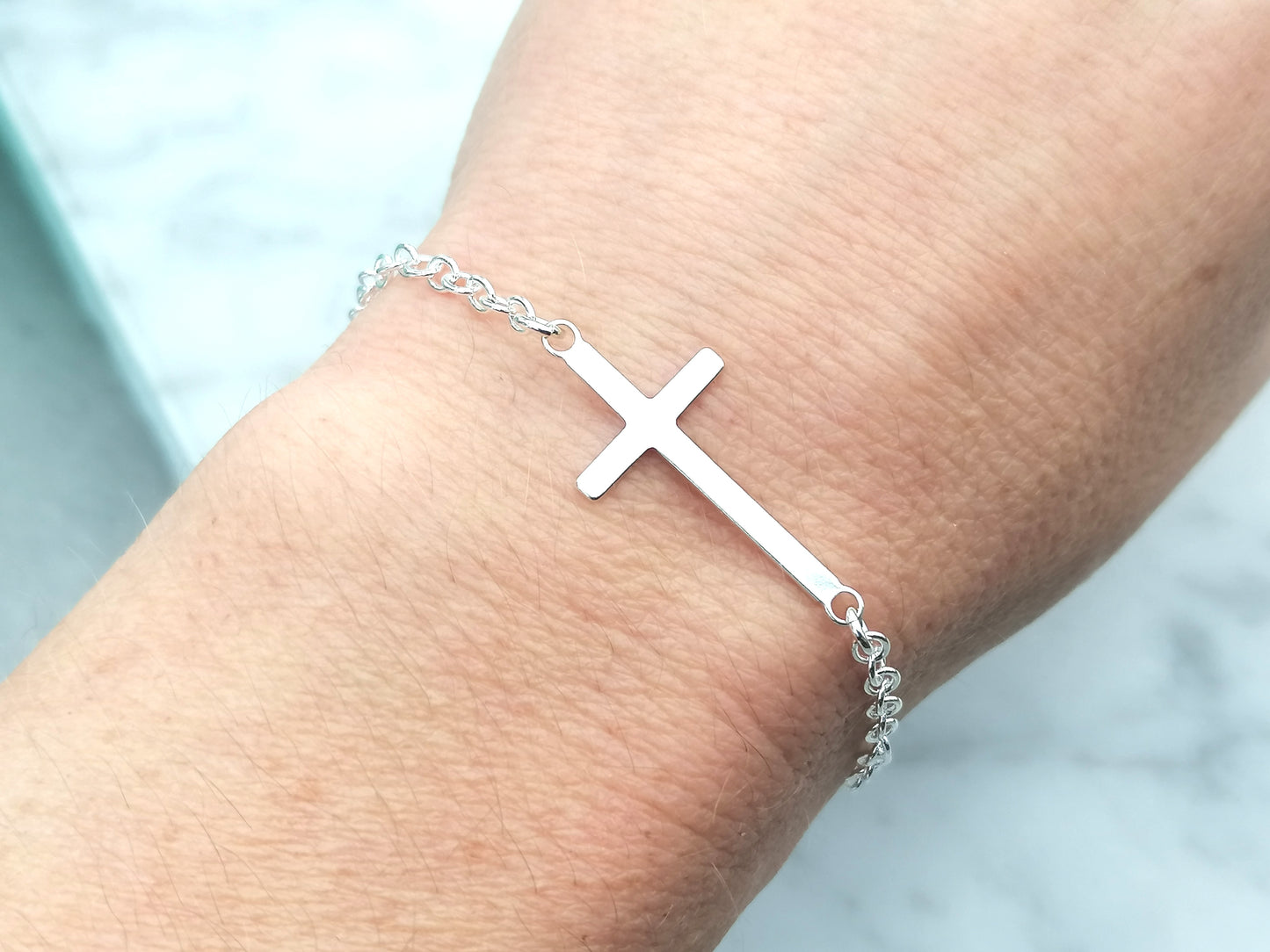 Adjustable sideways cross bracelet.