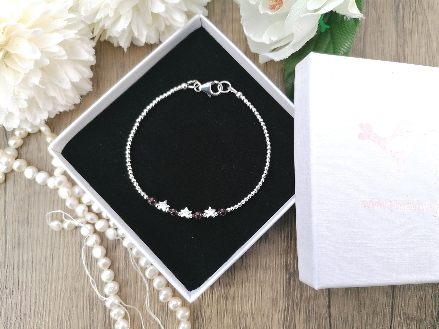 Star bracelet with garnet gemstones. January birthstone.